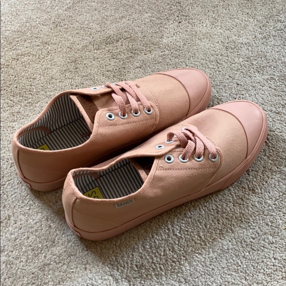 Desert rose colored bangs lace up shoes.